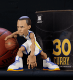 Stephen Curry collectible figurine in a Golden State Warriors white jersey.
